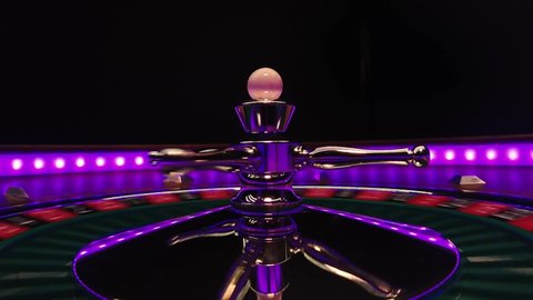 Close up slow motion of a spinning roulette wheel at the casino table