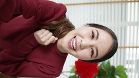 Vertical view selfie videocall shot of attractive beautiful young asian lady in red chinese new year celebration outfit happy smile talk and looking to camera mobile phone wishing for lunar festival. - Powered by Shutterstock - Get 15% off with code: PIKWIZARD15