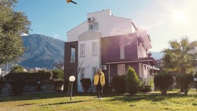 Smiling Woman Stands on a Porch While Flying Drone Delivers Her Postal Package to Her. Contactless Delivery Concept People Receiving Medical Aid, Essentials and Food Delivery in the Safety of Home - Powered by Shutterstock - Get 15% off with code: PIKWIZARD15