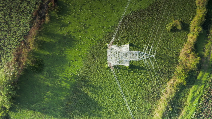 Transmission tower, power tower or electricity pylon. Consist of steel structure framing to support or carry cable, high-voltage powerline or overhead power line. For electrical grid in aerial view. | Shutterstock HD Video #1065745387