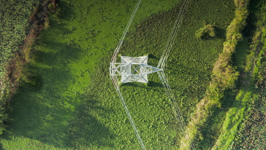 Transmission tower, power tower or electricity pylon. Consist of steel structure framing to support or carry cable, high-voltage powerline or overhead power line. For electrical grid in aerial view. Royalty-Free Stock Footage #1065745387
