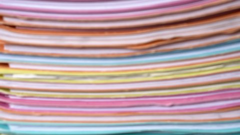 Blurred of Stack of multi colors file folders to clearly.