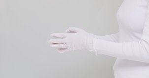 Close up female take off medical protective gloves. Caution preventive measures due COVID-19 pandemic epidemic disease