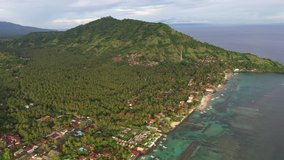 Aerial footage of the Candidasa resort town and its beach in eastern Bali in Indonesia