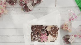 Time lapse. Flat lay. Step by step. Packaging homemade fudge and cookies into a Christmas gift box.