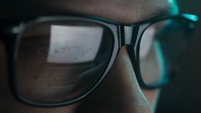 Businessman working at night looking at monitor, reflections in eyeglasses. Person stock market trader using laptop at office or home office. Business concept. Distance work. - Powered by Shutterstock - Get 15% off with code: PIKWIZARD15