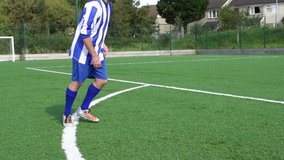 Scoring Free Kick during a Football or Soccer Match. The player kicks the ball past the goalkeeper. Super Slow Motion. Stock Video Clip Footage