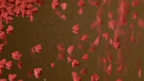 Red scarlet heart shaped sugar confetti fall down scatter reflect in mirror surface. Romantic love, affection or Saint Valentine's Day preparation design concept