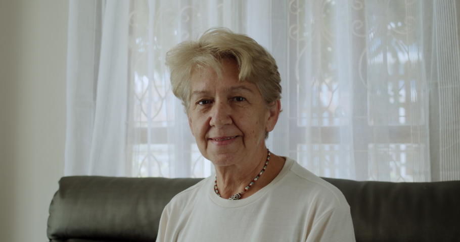 A nice senior woman smiles to camera.
