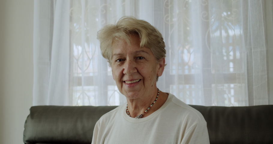 A nice senior woman smiles to camera.