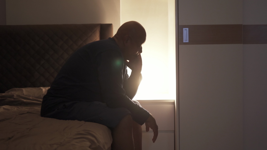Depressed lonely old elderly black man. African American people sitting on bed in bedroom at home. Lifestyle on late night. Insomnia. Quarantine | Shutterstock HD Video #1065776671
