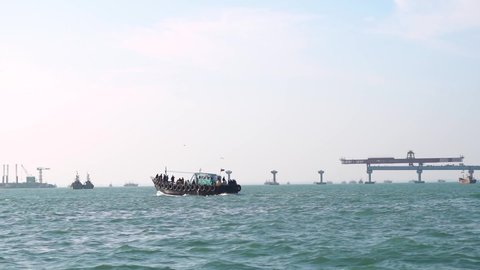 Boat in the sea moving in front of the Signature cable bridge under construction between Okha and Beyt Dwarka at Gujarat, India Stockvideo