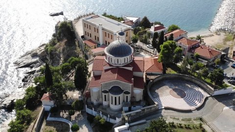 Aerial of the church by the cliff of Kavala bay, Greece.
