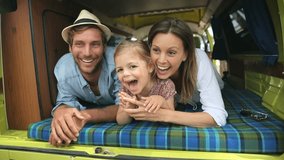 Portrait of cheerful family having fun in camper