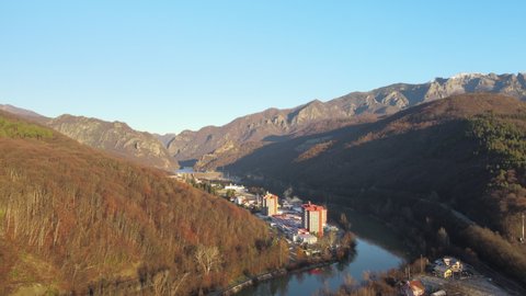 Aerial drone Caciulata Hotels in Valcea. Cozia Monastery near Olt River bridge environment in mountain Olt Valley beautiful gorge river in Romania, defile carved valley near national park