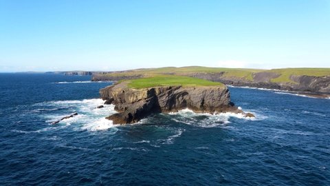 Aerial view over Illaunonearaun island, a natural heritage area, near Kilkee off the west coast of Ireland. The natural beauty of the cliff edge and blue Atlantic ocean. Ireland county Clare.