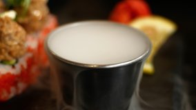 Dry ice fog stream. Close-up 4K video chemical reaction with water. Side view of a dry ice meal serving in a restaurant.