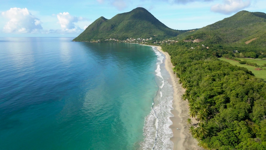 Scenic beach on Caribbean island for summer holidays vacation, 4k aerial video footage from drone of Martinique, Antilles with beautiful blue sea water and sandy coastline | Shutterstock HD Video #1065809899