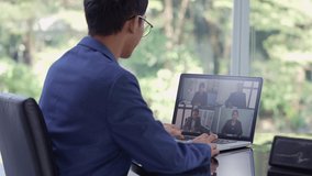 Young Asian businessman working from home having Online group videoconference on laptop, Asian business people video conference online on laptop, Online concept.