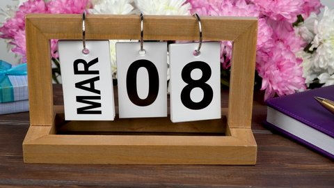 Desktop calendar with the date of March 8 and a bouquet of beautiful flowers. Delicate chrysanthemums for International Women's Day