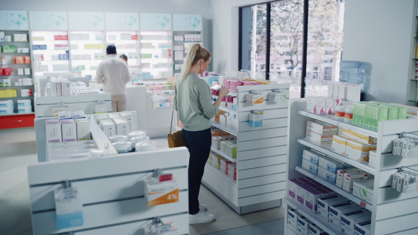 Pharmacy Drugstore: Diverse Group of Multi-Ethnic Customers Browsing, Purchasing Medicine, Drugs, Vitamins, Supplements, Health Care Products from Professional Pharmacist at Cashier Checkout Counter Royalty-Free Stock Footage #1065814387