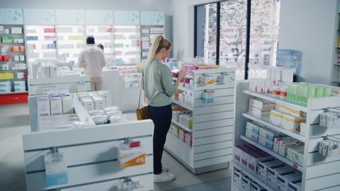 Pharmacy Drugstore: Diverse Group of Multi-Ethnic Customers Browsing, Purchasing Medicine, Drugs, Vitamins, Supplements, Health Care Products from Professional Pharmacist at Cashier Checkout Counter