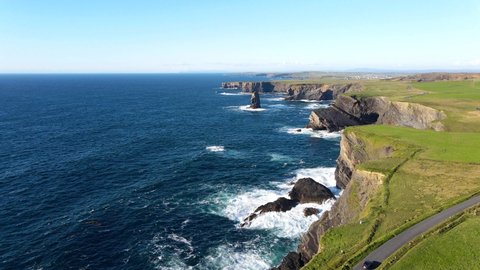 Aerial view over the Kilkee Cliffs. Beautiful rugged coast line with spectacular sea stacks. The natural beauty of the cliff edge and blue Atlantic ocean. Wild Atlantic way. Ireland county Clare.