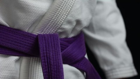 Tying up a Brazilian Jiu Jitsu purple belt