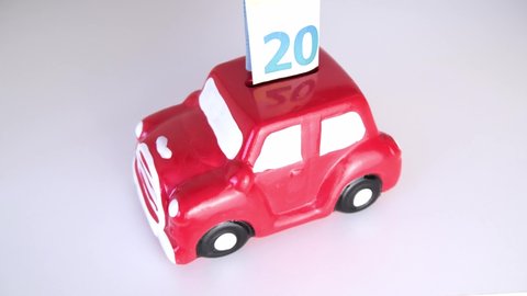 hand puts money in the car piggy bank. Savings for a new car. Car on credit. car loan.