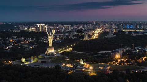 Kiev, Ukraine, circa 2019 - Establishing Aerial View Shot of Kyiv Kiev, glorious The Motherland Monument, Lesi Ukrainky Blvd, Ukraine at night evening