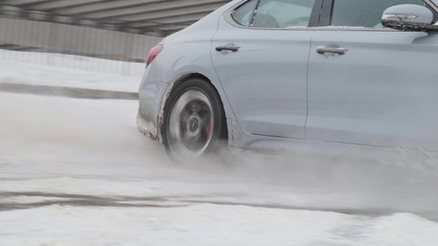 Moscow, Russia - CIRCA 2020: New car model Genesis G70 gray-blue on the road. Drift colse up