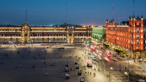 Day to night time lapse view of people and traffic around historical landmarks Zocalo Square (Spanish: Plaza del Zocalo ) and National Palace in the Historic Center of Mexico City, Mexico. 