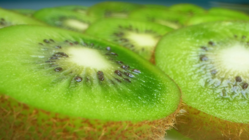 extremely close-up, detailed. slices of bright juicy green kiwi.