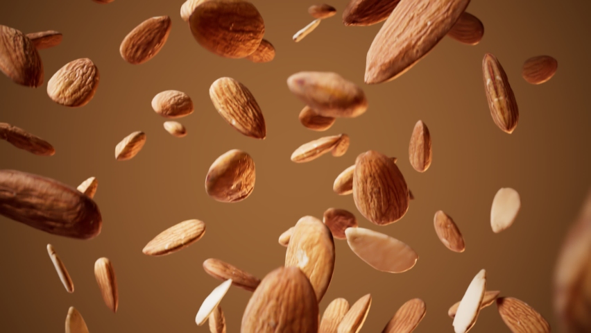 Seamless looping animation of falling down almonds on a light brown background. Delicious healthy snack ready to eat. Food advertising. Tasty crunchy nuts. Vegan. Slow-motion shot. Dessert ingredient Royalty-Free Stock Footage #1065848767
