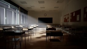 Rays of light falling to the empty dark classroom. The camera panning behind rows of desks and chairs. Teaching class without students during a break. Abandoned school. Disturbing mood. - Powered by Shutterstock - Get 15% off with code: PIKWIZARD15
