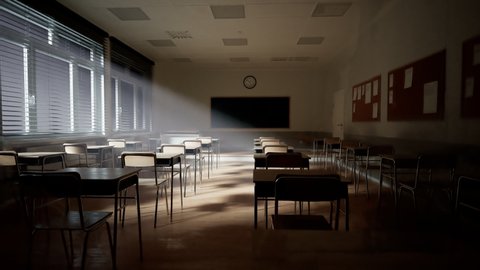 Rays of light falling to the empty dark classroom. The camera panning behind rows of desks and chairs. Teaching class without students during a break. Abandoned school. Disturbing mood.
