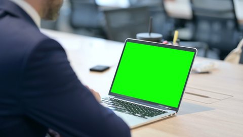 Businessman Using Laptop with Green Chroma Screen 