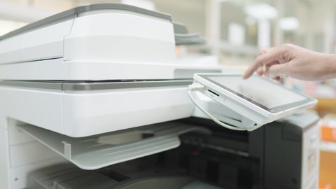 Employees are using copy paper at the office copier.