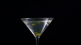 Slow Motion Martini Glass Shatters As An Olive Drops Onto The Lip Of The Glass - Powered by Shutterstock - Get 15% off with code: PIKWIZARD15