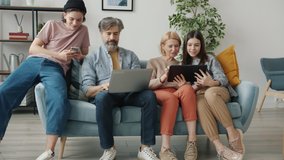Parents and children using laptop tablet and smart phone sitting on couch at home talking sharing gadgets content. People and modern technology concept. - Powered by Shutterstock - Get 15% off with code: PIKWIZARD15