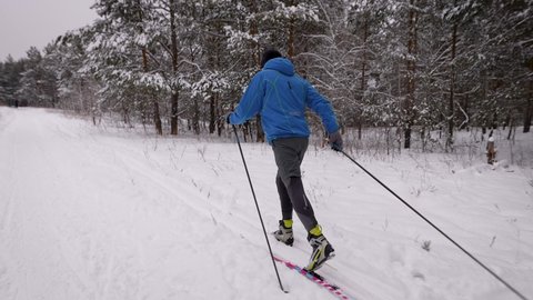 Sports lifestyle. A man on cross-country skiing in the winter forest. Preparing Adlı Stok Video