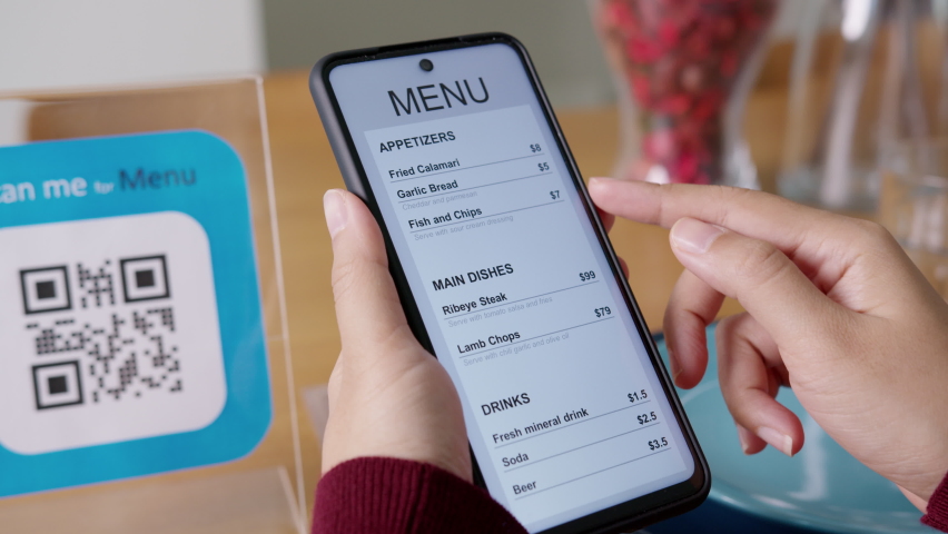 Hand's customer scan QR code for online menu service at table in restaurant during pandemic coronavirus. New normal contactless technology lifestyle protection coronavirus pandemic in restaurant - Powered by Shutterstock - Get 15% off with code: PIKWIZARD15