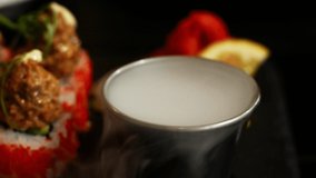 Dry ice fog stream. Close-up 4K video chemical reaction with water. Side view of a dry ice meal serving in a restaurant.