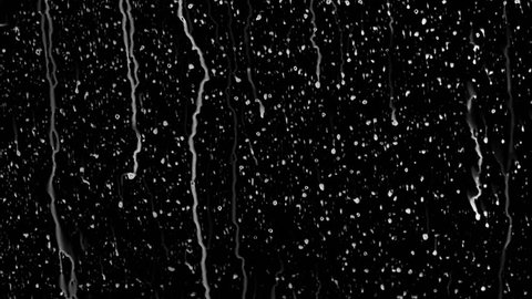 Raindrops of white water falling down on glass. Perfect for digital composing. Pure black background.