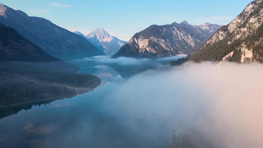 Plansee, Tyrol, Austrian Alps - 4K 24fps Aerial - Flying Above the Water and a Sea of Fog at Sunrise | Shutterstock HD Video #1065872989