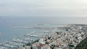 Marina dron 4K video. Aerial view of a port with boats and ships standing on the shores of the Mediterranean Sea in Palma on the island of Mallorca with historic buildings on the waterfront