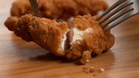 Chicken Tender is pulled apart revealing the meat inside