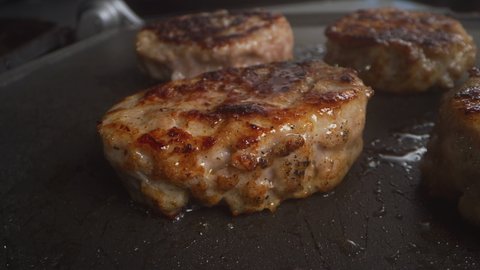 Breakfast sausage patty on the grill, slow motion.
