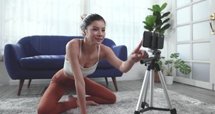 Young Asian woman doing yoga stretching at home, Online yoga classes.
