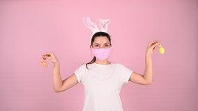 Easter in a pandemic, on a pink background. High quality video.